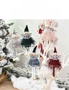 Close-up of handmade angel ornaments with lace collars and soft feather skirts