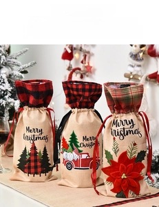 Detail of Christmas burlap wine bags with festive tree, truck and gnome embroidery