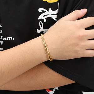 6mm 18k gold plated stainless steel twisted rope bracelet worn on a male wrist