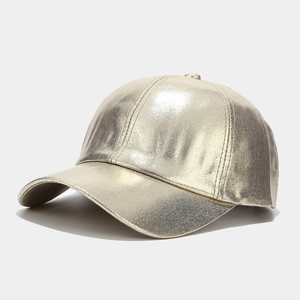 Detailed side view of golden PU leather baseball cap with metallic pearlescent texture