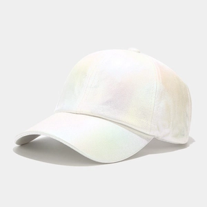 Detail of holographic white baseball cap with pearl finish and iridescent metallic texture