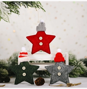 Close-up of felt star ornaments with knit hats and buttons for Christmas tree decor