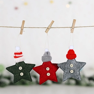 Close-up of felt star ornaments with knit hats and wooden buttons hanging on a rope