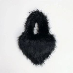 Detail view of heart-shaped black faux fur handbag with thick fibers and plush handle