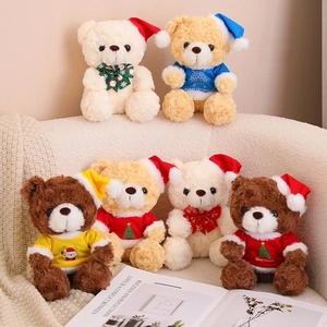 Detailed view of six Christmas teddy bears in various colors on a beige sofa