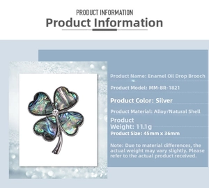 Detail view of silver four-leaf clover brooch with natural shell texture and alloy specs