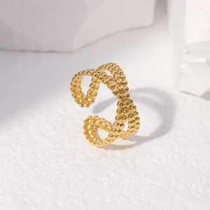Detail of adjustable gold ring with double-row metal beads and polished finish