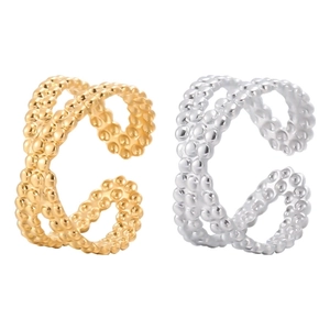 Detail of double-layer crossover rings with beaded texture in gold and silver finish