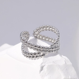 Minimalist silver multi-layer beaded adjustable stainless steel ring on a rock display