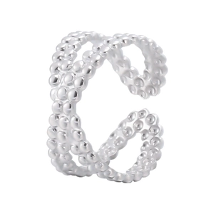 Detailed view of silver stainless steel ring with double-layered hollow dotted texture