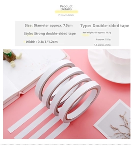 Detailed view of strong double sided tape rolls in various widths on a pink desk background