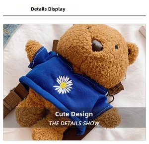 Detailed close-up of a plush bear bag in a blue hoodie with daisy print and soft texture