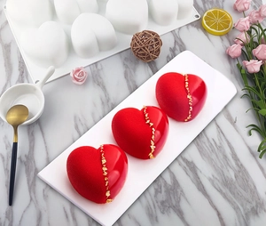 Detailed view of 3D heart mousse cake with half-matte half-gloss finish on marble surface