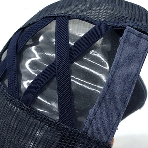 Detail of the criss-cross elastic bands on a navy mesh ponytail baseball cap for women