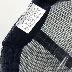 Close-up of the wash care label on a washed cotton ponytail baseball cap with fabric details