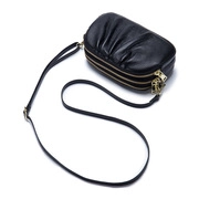 Detail view of black ruffled PU leather crossbody bag with multiple zip compartments
