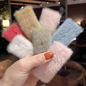 Selection of colorful plush hair clips in red, beige, gray, and pink colors