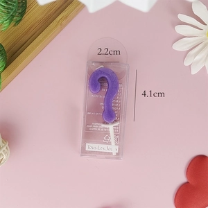Macro detail of purple question mark birthday candle showing 4.1cm height and 2.2cm width