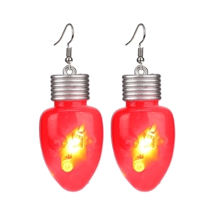 Detail of red LED Christmas bulb earrings with silver hooks and glowing warm yellow light