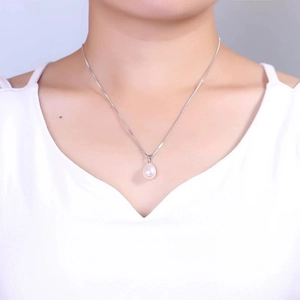 Elegant woman wearing S925 silver necklace with white rice-shaped freshwater pearl pendant