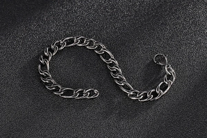 Detailed view of vintage silver Figaro chain bracelet with oxidized steel finish and clasp