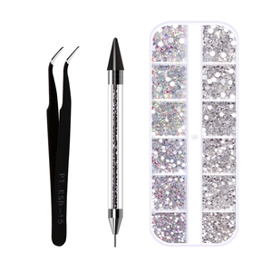 Close-up of nail art dotting tools with tweezers and mixed rhinestones kit
