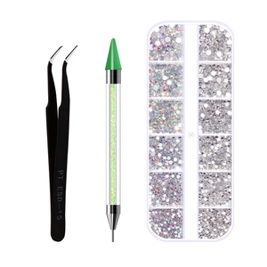 Close-up of nail art kit featuring tweezers, dual-ended dotting pen and rhinestone organizer