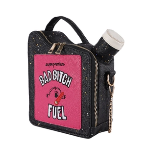 Close-up of black sequined oil can bag with pink patch and Bad Bitch Fuel embroidery