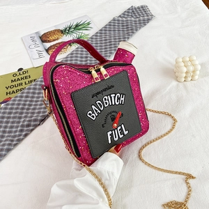 Detailed top view of magenta fuel tank bag with BAD BITCH FUEL embroidery and chain strap