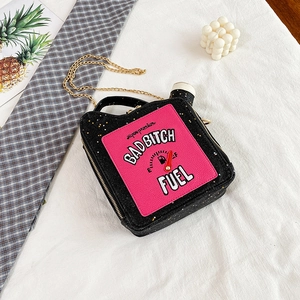 Macro shot of creative oil drum bag featuring sequins and BAD BITCH FUEL embroidery detail