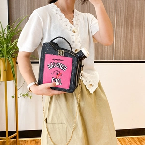 Detail of unique oil drum shaped crossbody bag with Bad Bitch Fuel embroidery and chain strap