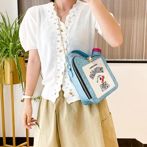 Blue glitter oil tank bag with Bad Bitch Fuel embroidery worn by a model in lifestyle view
