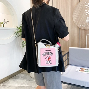 Detailed view of creative oil barrel handbag with glitter finish and chain strap