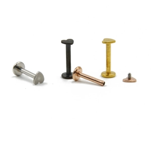 Detailed view of colorful heart-shaped stainless steel labret studs in various finishes