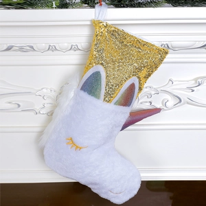 Plush white unicorn Christmas stocking with golden sequins and rainbow horn decoration