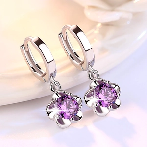 Silver flower drop earrings featuring a brilliant round purple zircon in a floral setting