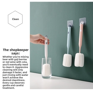 Detail of long handle sponge cup brushes in pastel colors with wall hanging hooks