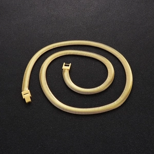 Mens 8mm golden stainless steel flat snake bone chain necklace on black background