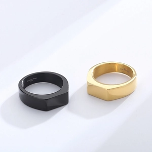 Macro detail of 316L stainless steel engraving on minimalist black and gold rings
