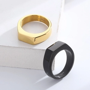 Detail of 316L stainless steel rings in gold and black with flat geometric design