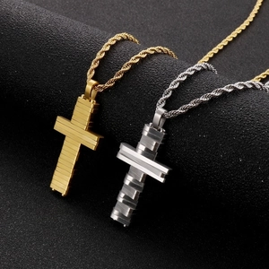 Macro view of gold and silver stainless steel cross pendants with frosted texture detail