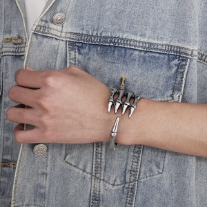 Gothic skull hand claw cuff bracelet in vintage silver finish worn on wrist