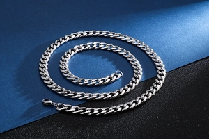 Close-up of polished silver stainless steel Cuban link chain with lobster clasp