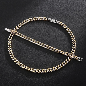 Classic two-tone gold and silver Cuban link necklace with square clasp on black background
