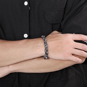 Vintage silver titanium steel twisted rope bracelet for men on a black shirt sleeve