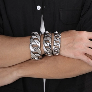 Polished silver stainless steel Cuban link bracelets in three widths worn on male wrist