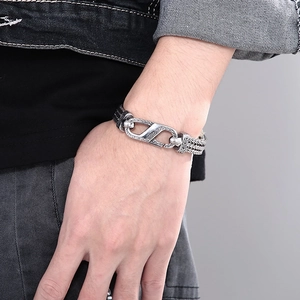 Detail of vintage braided stainless steel bracelet with engraved security clasp for men