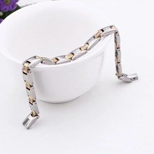 Two-tone magnetic therapy bracelet in gold and silver steel with cubic zirconia