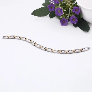 Detail of two-tone stainless steel magnetic bracelet with sparkling cubic zirconia inlay