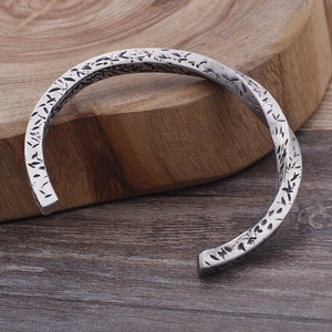 Detail of vintage silver titanium steel open cuff bracelet with twisted hand-hammered texture